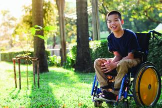 child outside in a wheelchair