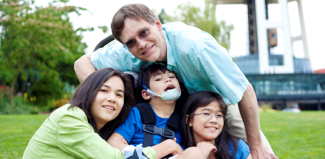 a family with a child with special needs enjoying a beautiful day outdoors